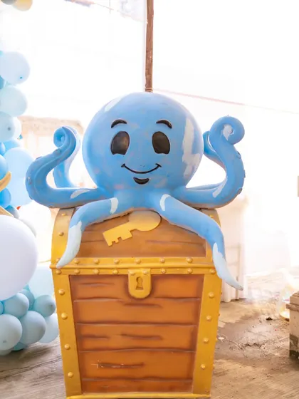 A friendly octopus guarding a treasure chest. Custom props like this are key to building an immersive, story-like environment for the kids.