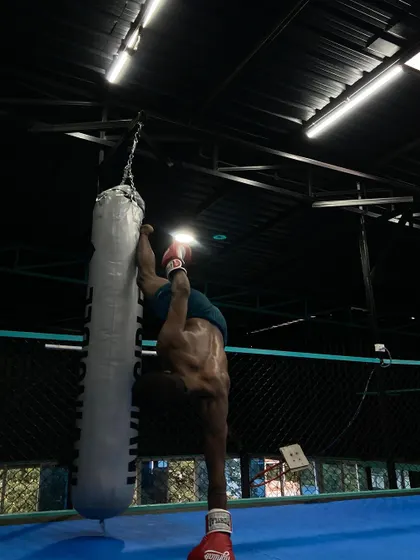 We believe in building functional strength in unconventional ways. Here, an athlete shows incredible core strength and body control by performing a handstand against a heavy bag.