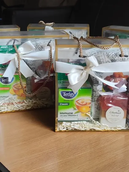 A simple 'thank you' can be made memorable. This curated hamper includes green tea, instant coffee, healthy snacks, and my own handmade honey oat milk soap, presented in a clear gift bag for a professional touch.