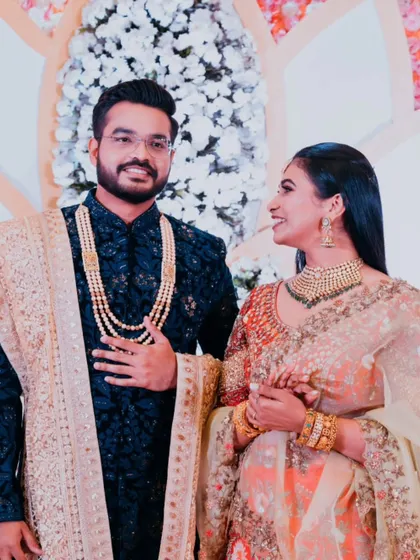 A candid moment of admiration between the bride and groom on their reception stage.