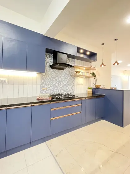 This deep blue kitchen features elegant rose gold handles for a touch of luxury. I used a combination of white subway tiles and patterned tiles for the backsplash to add visual interest and character.