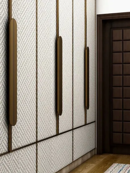 A close-up of the wardrobe doors, showing the beautiful herringbone texture of the laminate and the sleek, modern handles. This detail highlights our use of interesting and high-quality materials.