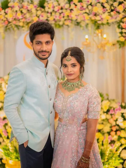 The couple against a beautiful floral backdrop. This shows how the makeup looks in professional photos, which is key for any event.