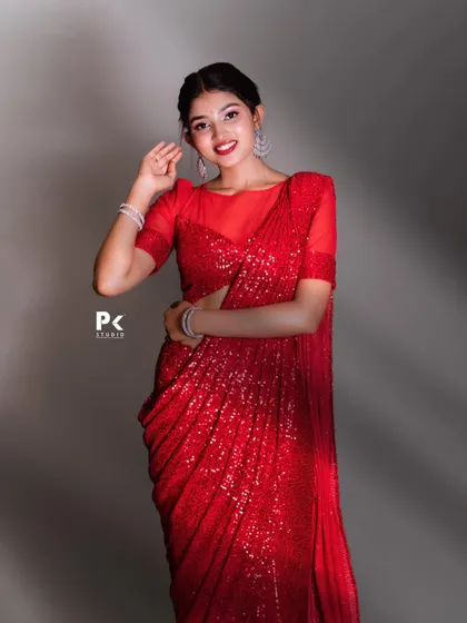 A smiling portrait in the red sequin saree, perfect for a cocktail party or reception.