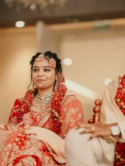 A candid moment during the wedding ceremony, capturing the bride's attentive expression as she listens to the priest.