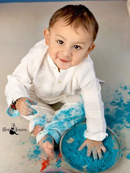 A close up of this little boy's hands covered in blue, showing his curiosity and playful nature.