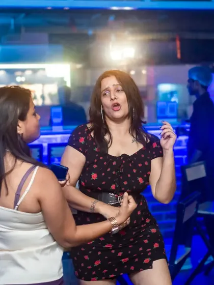 Two friends dancing together, lost in the music and the moment. The energy between them is infectious.