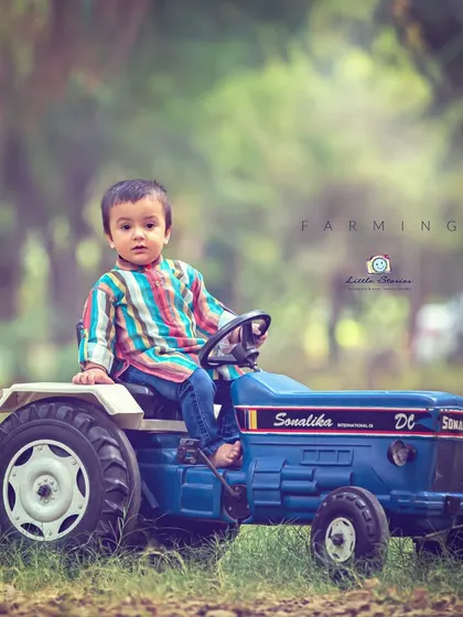 From the farm to the photo. This themed shoot with a toy tractor brings a touch of rustic charm and allows for imaginative play during the session.