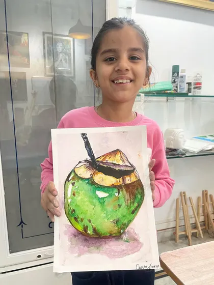 This refreshing coconut painting was made by a young student using watercolors. She learned how to create texture and capture the play of light on the surface.