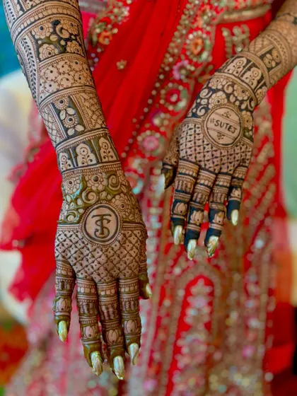A personalized bridal design featuring the couple's initials, "TS," and the groom's name, "Sutej," inside decorative circles. The background is a classic jaali pattern.