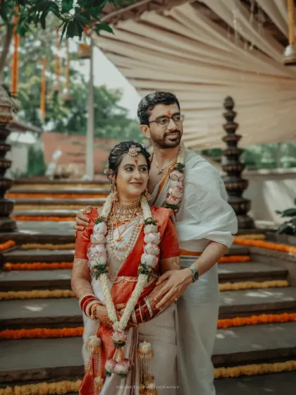 A classic portrait of the couple in their traditional South Indian wedding attire, looking towards their future together.