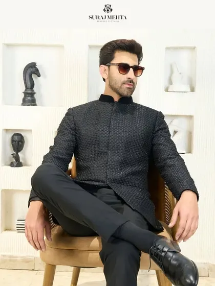 I redefine traditional attire with this sleek black Jodhpuri suit. The modern, sharp cut and textured fabric seamlessly blend heritage with contemporary flair, making it a perfect choice for a bold and stylish statement at a reception or formal gathering.