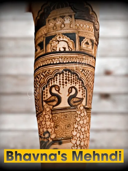 A close up of a breathtakingly detailed bridal arm. This design features graceful swans and elephants within ornate architectural frames, showcasing the highest level of intricacy.