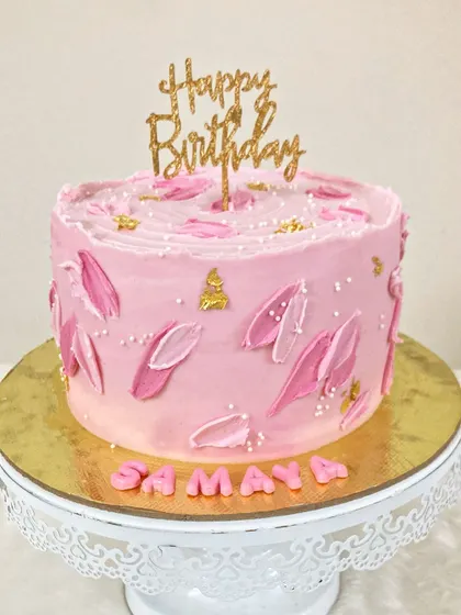 A modern take on a Barbie-themed cake. This pink ombre design features delicate, hand-painted petal details and a touch of gold for an elegant and graceful look.