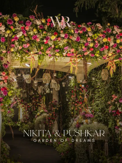 The 'Garden of Dreams' entrance, with the couple's name elegantly displayed. The dense floral arch is a perfect example of my style of whispered grandeur, lush but never over the top.