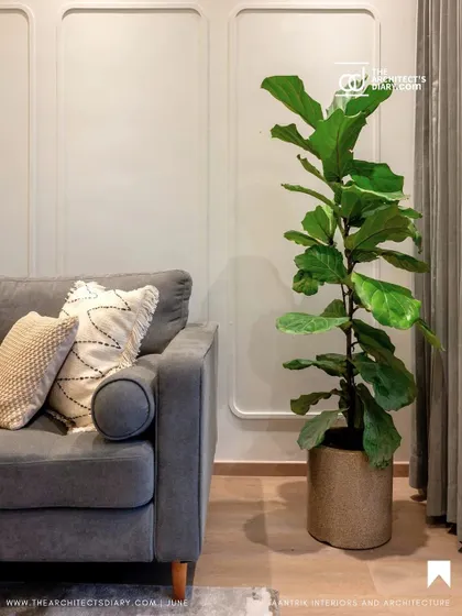 My 'Tranquil Tones' apartment project featured in The Architect's Diary. This living room shot highlights the use of simple wall paneling and a comfortable grey sofa to create a sanctuary for nature lovers.