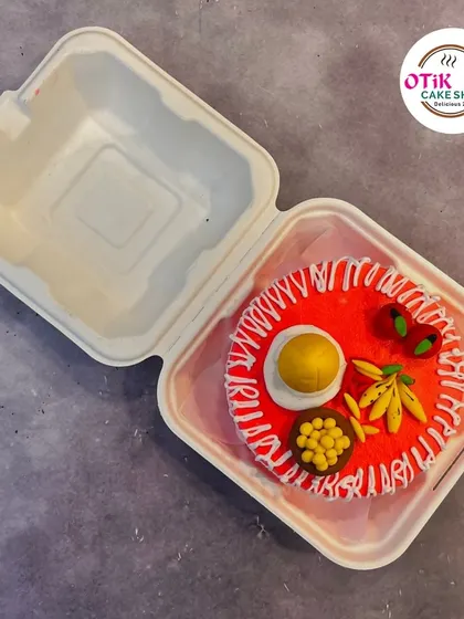A playful bento cake designed to look like a plate of Indian food, complete with edible 'ladoo' and 'chutney'. This showcases our ability to get creative with any theme.
