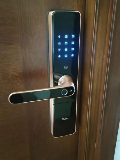 Here is another look at the Qubo smart lock on a client's door. Its black and rose gold finish complements modern wooden doors, adding a touch of elegance to your home's entrance.