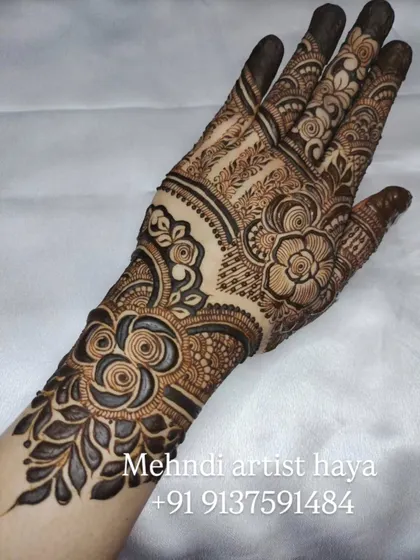 This design features bold, shaded roses on the forearm that transition into more intricate patterns on the hand, creating a balanced and elegant look.