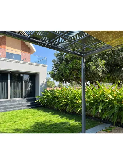 I designed this outdoor seating area for the Tranquil Mango Haven with a custom pergola. It provides a shaded, cozy spot to enjoy the garden, complete with a fireplace, making it a perfect place for relaxation in this English farm inspired weekend home.