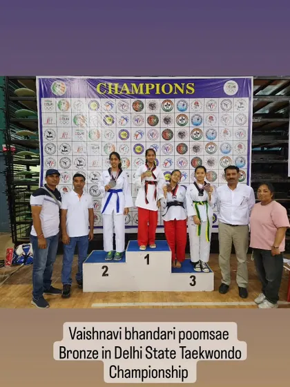 A student on the podium after winning a bronze medal in Poomsae at the 39th Delhi State Taekwondo Championship.