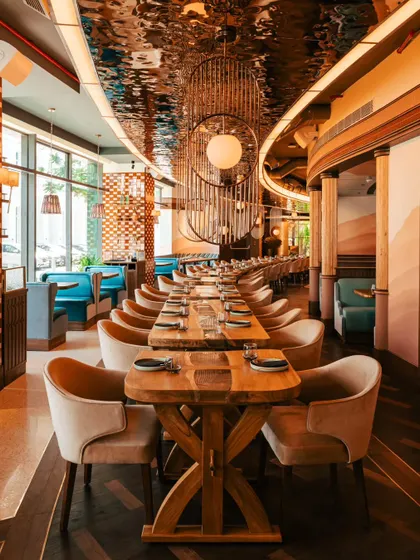 A wide-angle view of Comorin's dining room, emphasizing the sleek design and spacious layout. This type of architectural shot is key for showing off a restaurant's ambiance.