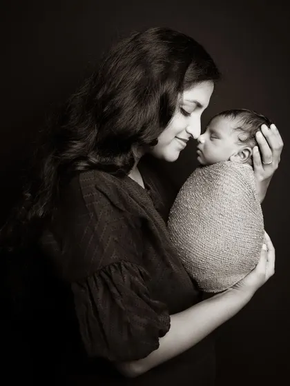 A timeless mother and child portrait, finished in a classic sepia tone to highlight the tender connection. These intimate shots are a beautiful part of any newborn session.