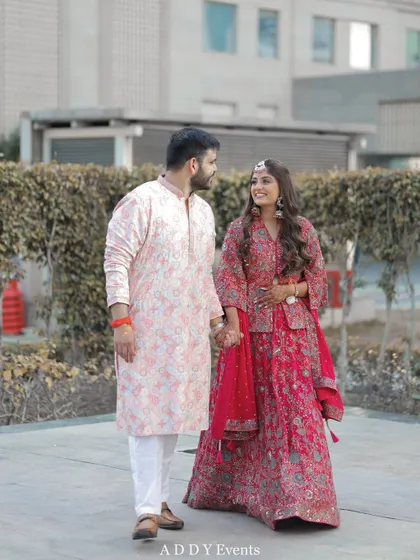 The couple walks hand-in-hand, sharing a look of love and happiness.