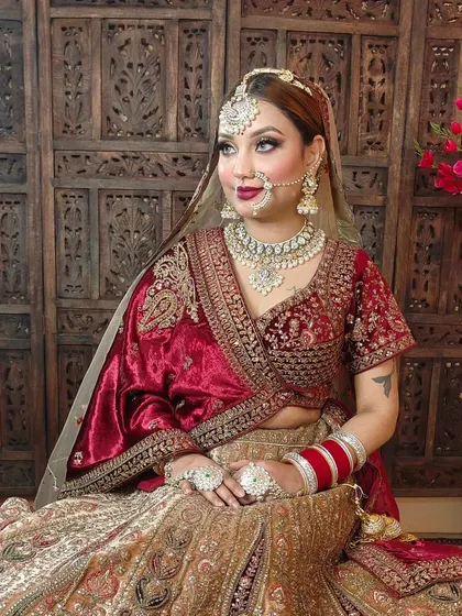 A full bridal look showing the heavy Polki jewellery set against a traditional red and gold lehenga. The matha patti, nath, and choker create a complete and cohesive look.