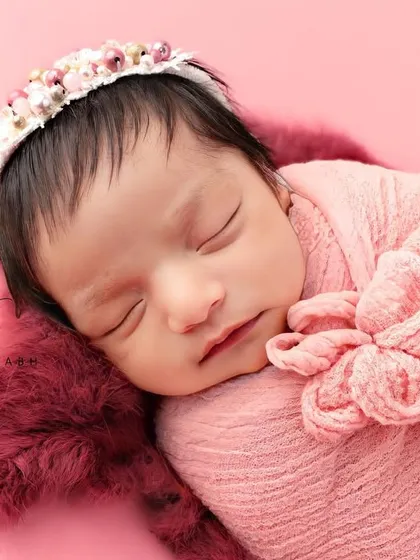 This angle showcases the beautiful floral headband that complements the pink theme perfectly.