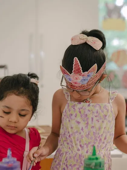A close-up of two young guests enjoying a painting activity. I make sure every child has the materials and guidance they need to create something they're proud of.