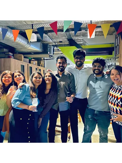 A group of friends celebrating a successful karaoke performance, smiles all around.
