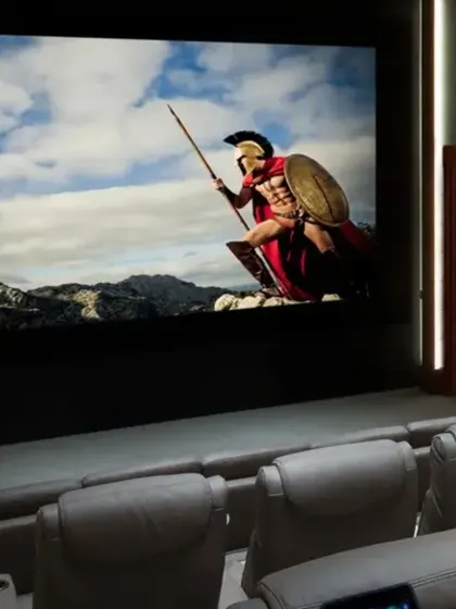 We bring globally renowned brands like Sony and JVC to your home. This setup, with its large projection screen and comfortable cinema-style seating, is expertly calibrated by our team to ensure the best possible audio and video experience.