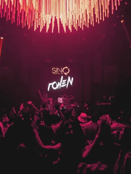 The dance floor at SinQ Nightclub under the glow of the chandelier and my logo. The atmosphere was sophisticated yet wild.
