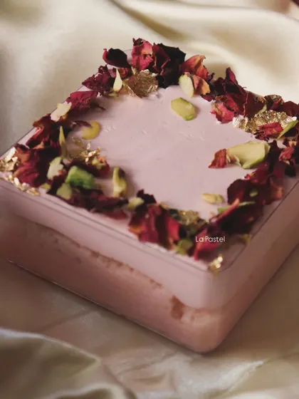 My Rose Tres Leches tub, a delicate and fragrant dessert made with rose-infused milk and topped with pistachios and edible gold.