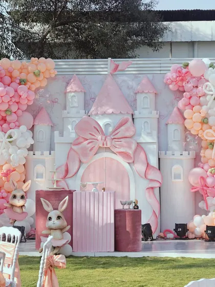 For a truly enchanting celebration, we designed this fairytale bunny and castle theme. The centerpiece is a custom-built castle with a large pink bow, surrounded by plush bunnies, elegant pedestals, and a soft pastel balloon arrangement, creating a magical photo opportunity for a first birthday or baby shower.