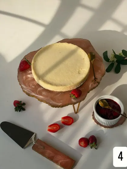 Playing with natural light to capture the simple beauty of my Baked Yogurt Cheesecake. The shadows highlight its smooth surface and the fresh strawberries waiting to be paired with it.