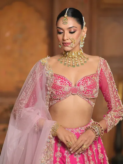 A demure pose showing the soft blend of pink and gold on the eyelids. The makeup is designed to be both beautiful in photos and comfortable to wear.