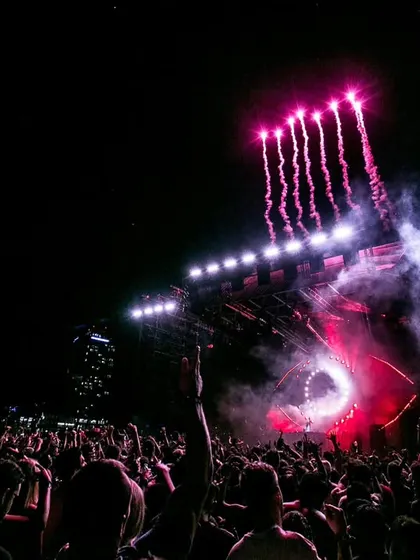 Pyrotechnics light up the night sky at a massive concert in Dubai. This shot is all about capturing the spectacle and the grand scale of modern music festivals.