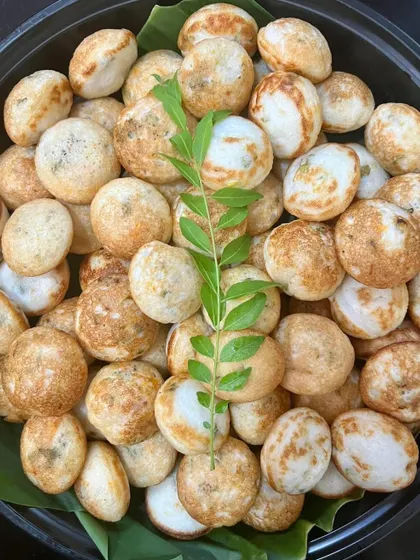 Freshly made Paniyaram, a classic South Indian snack, served as part of a special Sunday meal. I love using authentic recipes and fresh ingredients to bring comforting and delicious food to your family table.