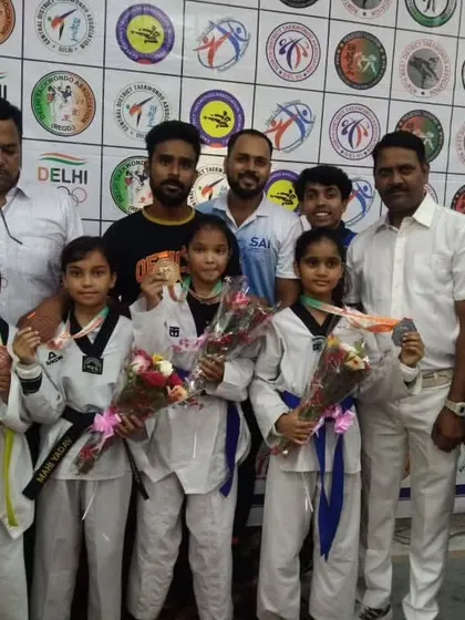 Our young female champions with their medals and bouquets at the 39th Delhi State Championship.
