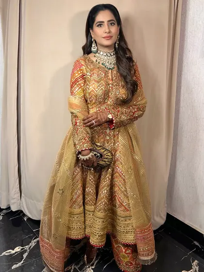 A full-length view of the client, her traditional outfit and glamorous makeup creating a stunning combination.
