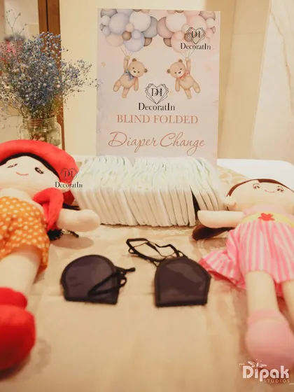 A "Blind Folded Diaper Change" game station, complete with dolls and blindfolds.