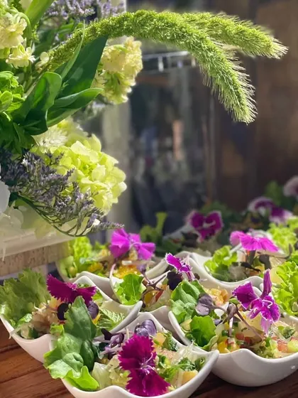 I believe salads should be a feast for the eyes. This creation features fresh greens, vibrant edible flowers, and a light dressing, showcasing my commitment to using beautiful, farm-to-table ingredients.