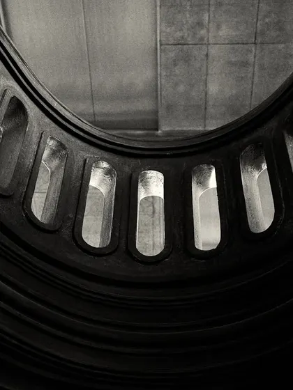 A similar abstract view of the balcony from below, creating a powerful graphic shape against the ceiling.