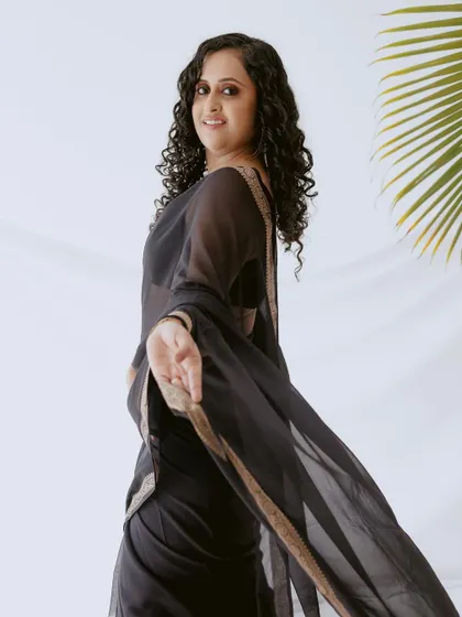 A playful, in-motion shot. The client is twirling, showing off her natural curls and the simple elegance of the look.