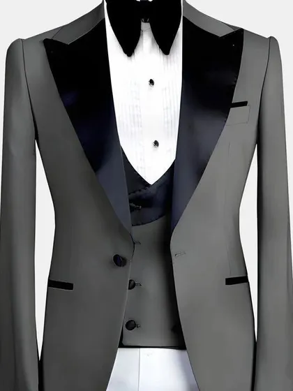 A grey three-piece tuxedo with black satin lapels. The color combination is modern and very sharp.