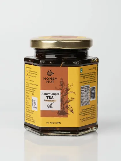 A jar of Honey Ginger Tea concentrate, photographed for an e-commerce listing. The clean reflection at the base adds a touch of professionalism.