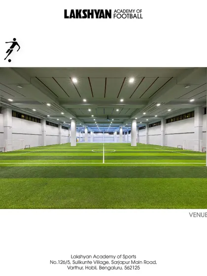 A wide shot of our indoor football arena, showcasing the expansive, well-lit space designed for high-level training and competition.