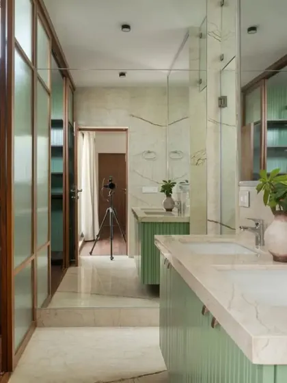 The light and airy master bathroom and walk-in wardrobe, where sage green cabinetry and marble create a fresh and luxurious feel.